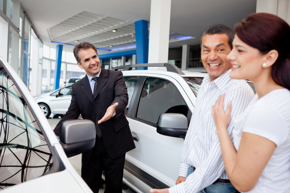 Couple at the dealership looking for a new car