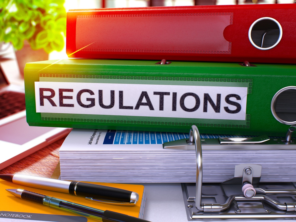 Green Office Folder with Inscription Regulations on Office Desktop with Office Supplies and Modern Laptop. Regulations Business Concept on Blurred Background. Regulations - Toned Image. 3D..jpeg