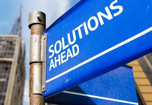 Solutions Ahead blue road sign.jpeg