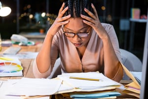 Stressed businesswoman sitting at her desk in the office-1