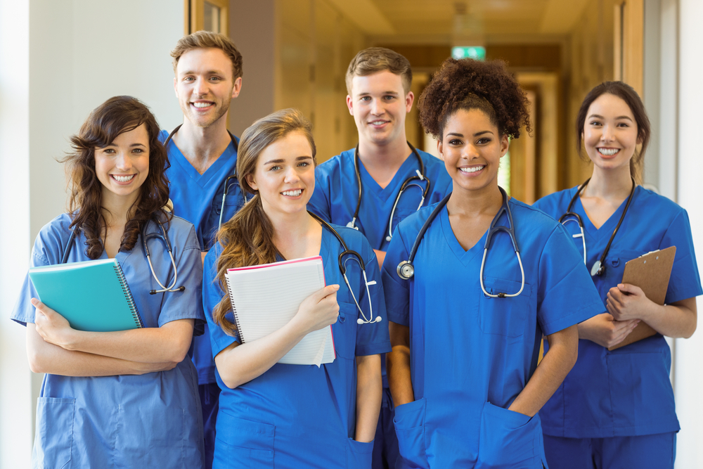 Medical students smiling at the camera at the university