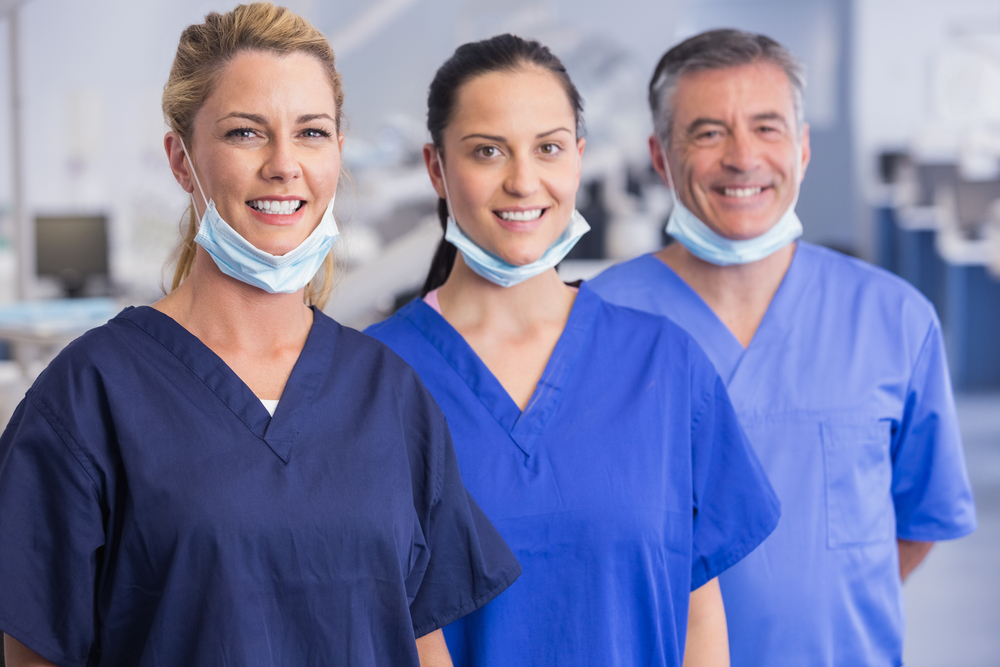 Portrait of smiling co-workers standing in a line in dental clinic-2