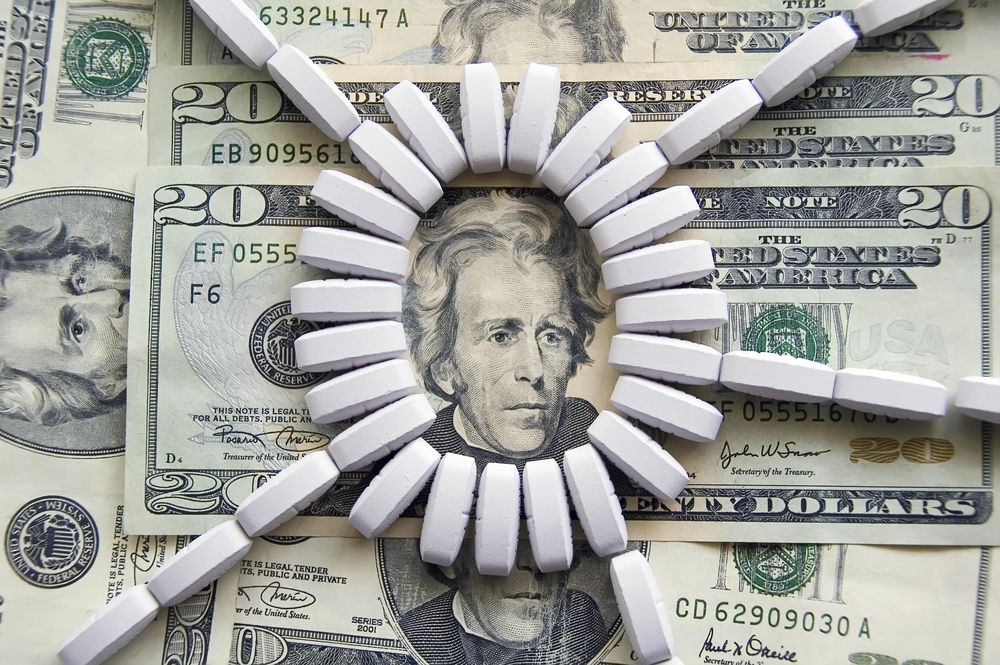 Ring of light-colored tablets on U.S. $20 bills