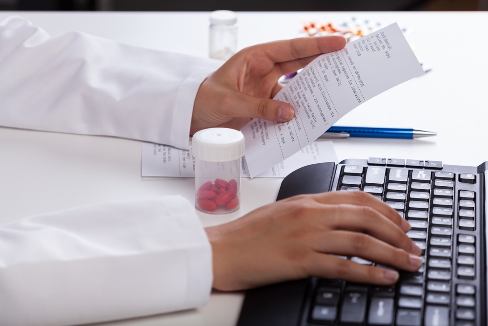 Pharmacist's hands checking information about medicines.jpeg